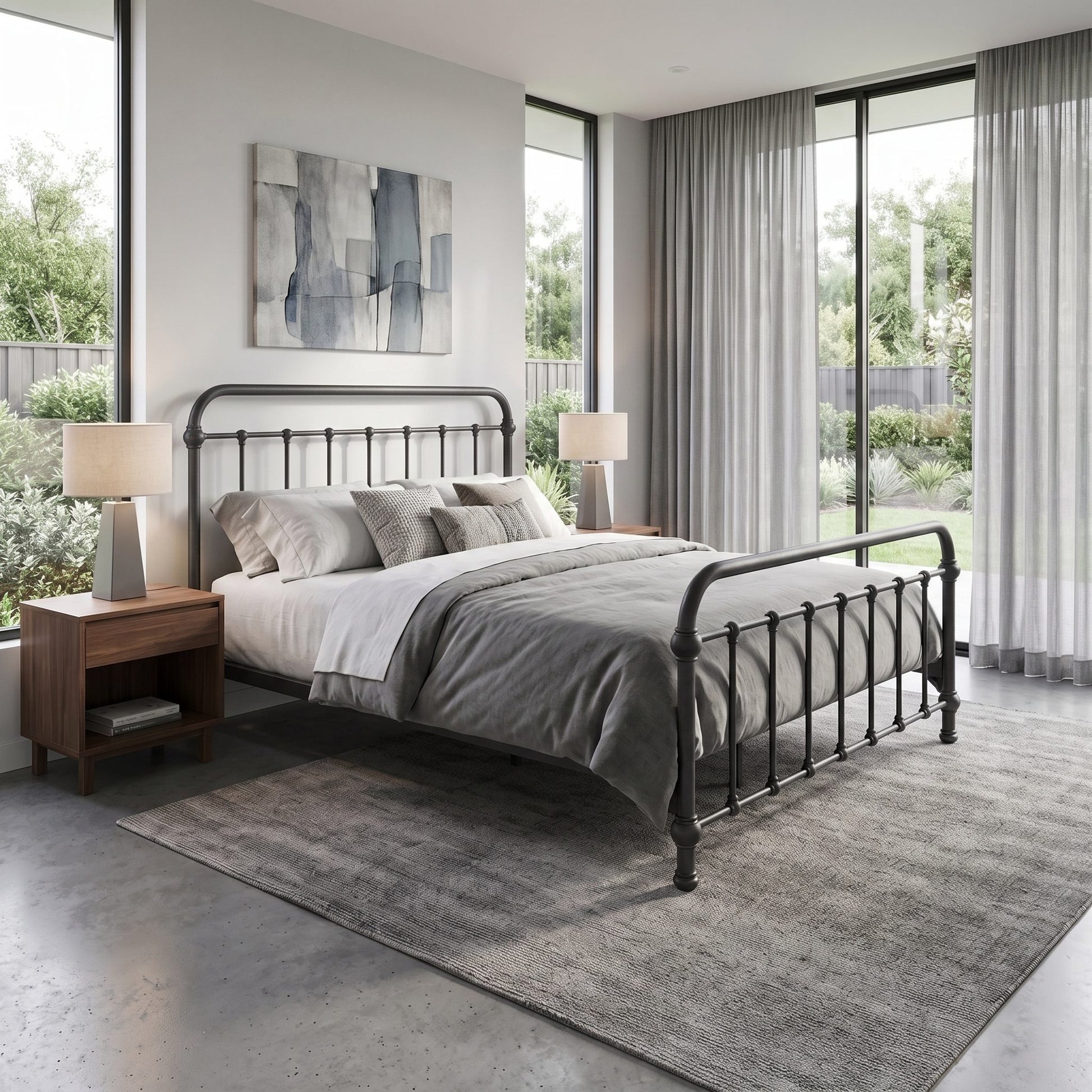 Heiressy 20th c Americana Iron Bed in Deep Pewter Finish. A modern bedroom featuring a black metal bed frame with a curved headboard and footboard, styled with gray and white bedding, flanked by wooden nightstands and lamps, set on a textured gray rug in front of large windows with sheer curtains.