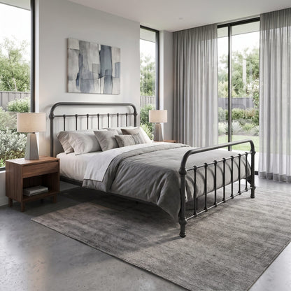Heiressy 20th c Americana Iron Bed in Deep Pewter Finish. A modern bedroom featuring a black metal bed frame with a curved headboard and footboard, styled with gray and white bedding, flanked by wooden nightstands and lamps, set on a textured gray rug in front of large windows with sheer curtains.