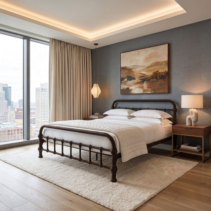 20th c Americana Low Profile Iron Platform Bed by Heiressy. A modern bedroom featuring a dark wood bed frame with white bedding, set on a plush cream rug against a textured gray wall with a landscape painting. The room includes a wooden nightstand with a lamp, beige curtains, and a large window overlooking a city skyline.