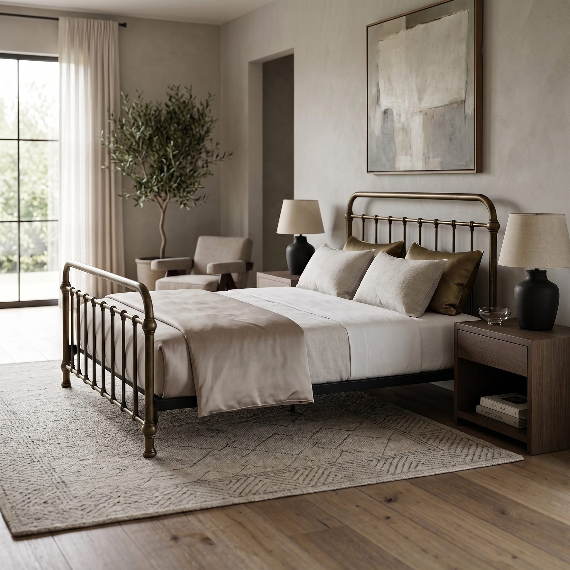 Heiressy 20th c Americana Iron Bed in Restored Brass Finish. A classic metal bed frame with an antique bronze finish, styled in a neutral-toned bedroom with white linens, matching nightstands, and a large area rug.