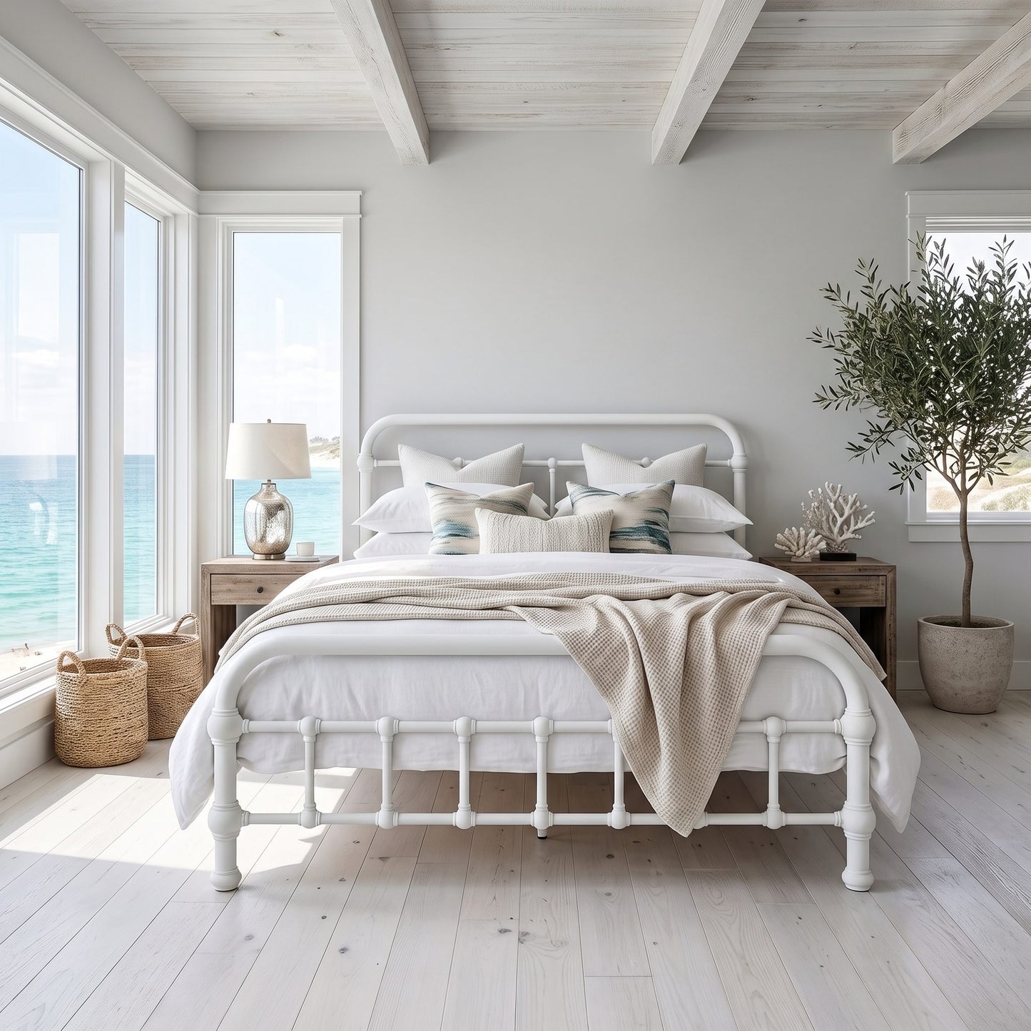 20th c Americana Low Profile Iron Platform Bed by Heiressy.  A white metal bed frame with a classic turned spindle foot design, styled with white linens, beige pillows, and a beige throw blanket in a bright, modern beach-style bedroom.